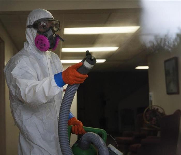 Servpro employee disinfecting facility